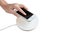Hand putting mobile phone on wireless charger, modern equipment,