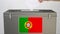 Hand putting paper ballot into ballot box with flag of Portugal. Election related clip