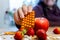 Hand putting pill strip among apple and strawberries healthy life choices