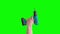 Hand raises cordless electric screwdriver with bit for screws, tools isolated on green screen. Mechanic tools concept