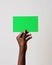 hand raising green blank card in front of white background