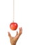 Hand reach to grab the hanging apple.