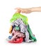 A hand reaches for a pile of clothes