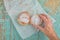 Hand reaches for sweet sugary donut on rustic table