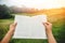 Hand read books. relax in the holiday. on a green pasture