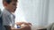 Hand-reading of blind child with braille book sitting on windowsill