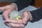 Hand-reared kea parrott nestling is sitting in hands