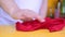 Hand with red rag wipes thoroughly from dirt and dust table or bar counter.