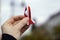 Hand with red and white ribbon on background. Flag background national holiday country november celebration.1 of May, November 11