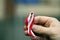 Hand with red and white ribbon on background. Flag background national holiday country november celebration.1 of May, November 11