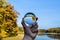 Hand, reflection in the glass ball, forest and lake in autumn