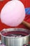 Hand rolling cotton candy in candy floss machine. Making candyfloss during street food festival