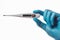 A hand in a rubber glove holds a thermometer. Fever as a sign of Coronovirus Covid-19