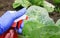 Hand in a rubber glove performs agricultural work on the processing of the spray from pests of green cabbage in the summer garden