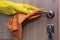 A hand in a rubber glove rubs the door handle. Disinfection at home during the epidemic, the virus