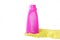 Hand in rubber yellow glove holds pink bottle of liquid bleach on white background. cleaning