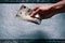 HandÂ´s of young man holding a money. Banknotes on a stone background. Euro money bank notes of different value.