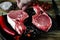 hand salt meat steak. Raw marbled meat steak, pepper, herbs, garlic, old wooden background. Space for text. Beef Rib eye steak