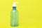 Hand sanitizer bottle or alcohol gel for hand cleasing on yellow backgoumd and copy space