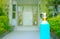 A hand sanitizer bottle placed on the left side of the picture on a blurred background is the entrance to the house