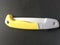 Hand saw for cutting and arranging fruit trees with a yellow handle on a black background,folding saw macro isolated