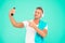 Hand selfie. Handsome man point finger at selfie camera in smartphone. Happy sportsman smiling take selfie with mobile