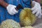 Hand seller is peeling durian for the buyer