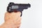 Hand with semi-automatic handgun closeup