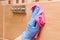 Hand of senior woman washing and wiping bathroom tiles using pink microfiber cloth, household duties concept