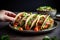 hand serving vegan tacos on a ceramic plate