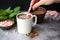 hand setting a spoon next to a cup of peppermint mocha