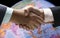 Hand shake background foreign currency