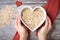 hand-shaped heart hovering above bowl of muesli