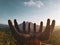 Hand shaped sculpture with Batur volcano during beautiful sunrise in Bali