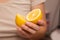 Hand Showcasing Half a Lemon. A person's fingers displaying a bright lemon half