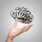Hand showing 3d metal human brain