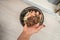 Hand showing composting worms from homemade sustainable waste disposal