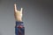 hand showing rock on or bulls horns gesture in studio shot isolated on grey background