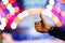 Hand showing thumbs great sign on natural bokeh blurred abstract background