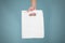 Hand shows blank plastic bag mock up isolated. Empty white polyethylene package mockup. Consumer pack ready for logo design or id