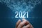 The hand shows the year 2021
