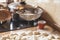 Hand sifts flour through sieve over dough pieces