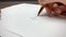 Hand signing writing on white paper isolated gold pen brown table with
