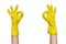 Hand simbol OK in rubber yellow gloves