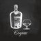 Hand sketched cognac bottle and glass. Vector illustration of brandy set on a chalkboard. Vintage alcoholic drink menu.