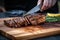 hand slicing grilled seitan steak on a grey board