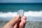 Hand with small stone on the beach