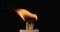 Hand spark off a wooden sticks in a match box. Matches lighting at dark background in slow motion. Bright burn macro