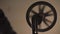 Hand spinning film reel, old movie projector