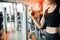 Hand of sports woman lifting dumbbell for weight training by hand for pumping biceps muscle with fitness gym background. Workout